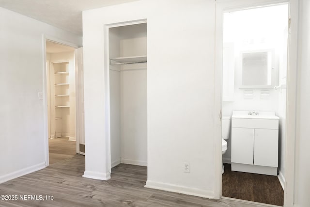 395 Arora Blvd, Orange Park, FL 32073 - unfurnished bedroom featuring a sink, wood finished floors, a closet, and baseboards