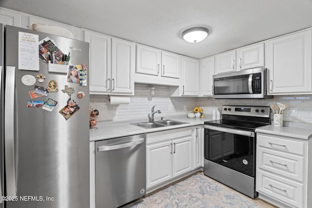 8880 Old Kings Rd S Unit 21, Jacksonville, FL 32257 - kitchen with tasteful backsplash, light countertops, white cabinets, stainless steel appliances, and a sink