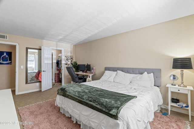 8880 Old Kings Rd S Unit 21, Jacksonville, FL 32257 - bedroom featuring light tile patterned floors, baseboards, visible vents, lofted ceiling, and a spacious closet