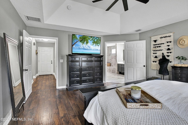 bedroom featuring visible vents, baseboards, wood finished floors, and ensuite bathroom