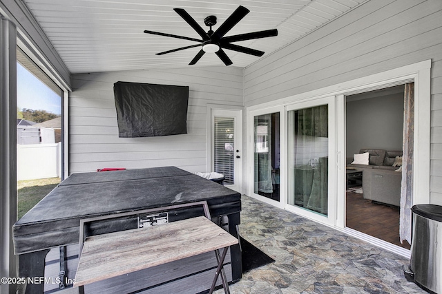 sunroom featuring ceiling fan and vaulted ceiling