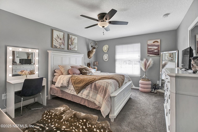 bedroom featuring ceiling fan, baseboards, dark carpet, and a textured ceiling