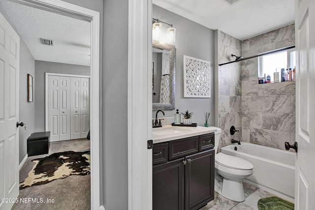 bathroom with visible vents, toilet, a textured ceiling, tub / shower combination, and vanity