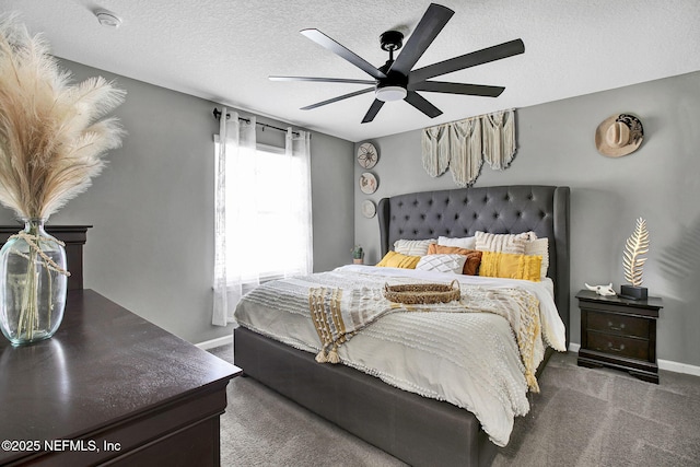 carpeted bedroom with baseboards, a textured ceiling, and ceiling fan