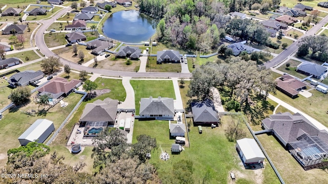 drone / aerial view featuring a residential view and a water view