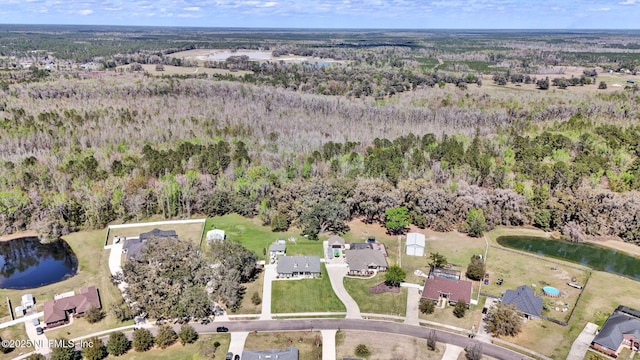 aerial view with a forest view and a water view