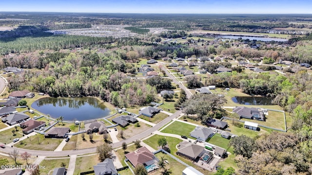 birds eye view of property with a residential view, a forest view, and a water view