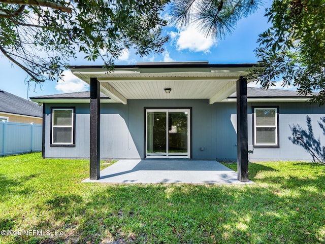 back of house with a yard, a patio, and fence