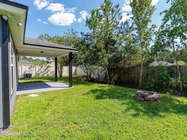 view of yard with a patio area, central air condition unit, an outdoor fire pit, and a fenced backyard