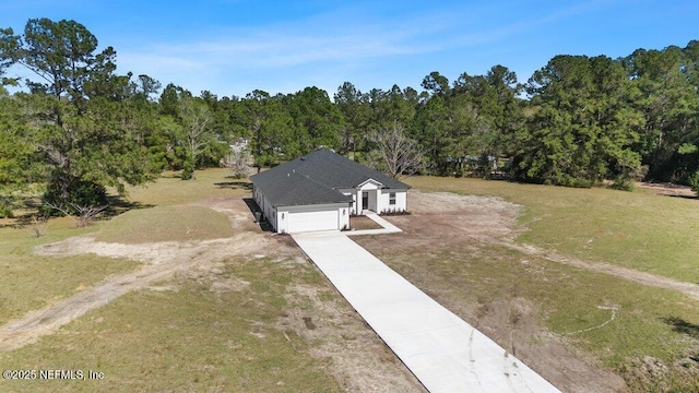 drone / aerial view with a wooded view