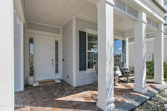 doorway to property featuring covered porch