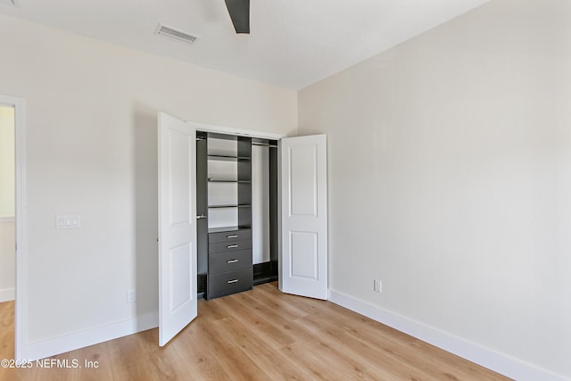 unfurnished bedroom with light wood-style flooring, baseboards, and visible vents