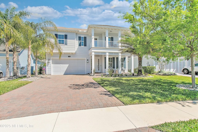 view of front of property with a front lawn, a porch, decorative driveway, a garage, and a balcony