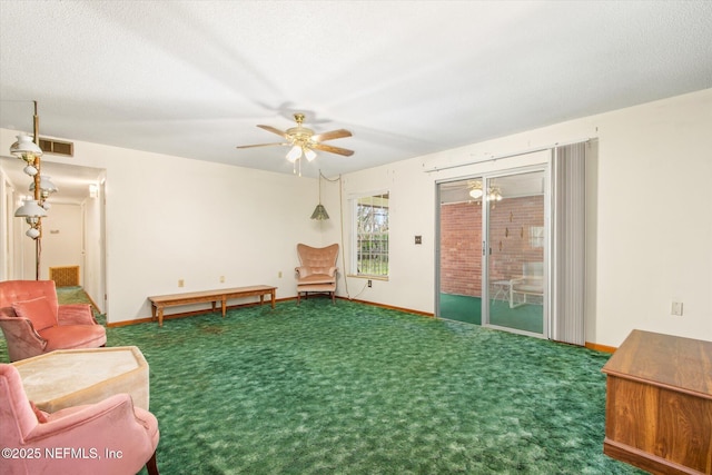 living area with baseboards, carpet, visible vents, and ceiling fan