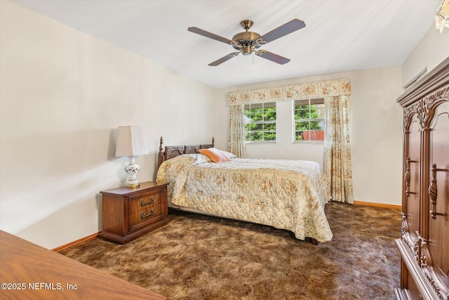 bedroom with dark colored carpet, baseboards, and a ceiling fan