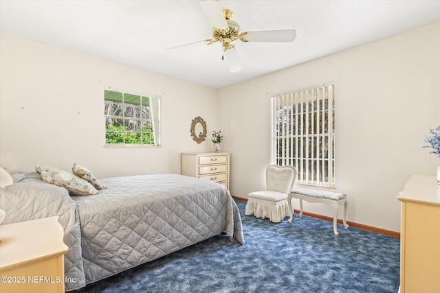 carpeted bedroom featuring baseboards and ceiling fan