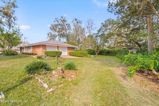 view of yard featuring an attached garage