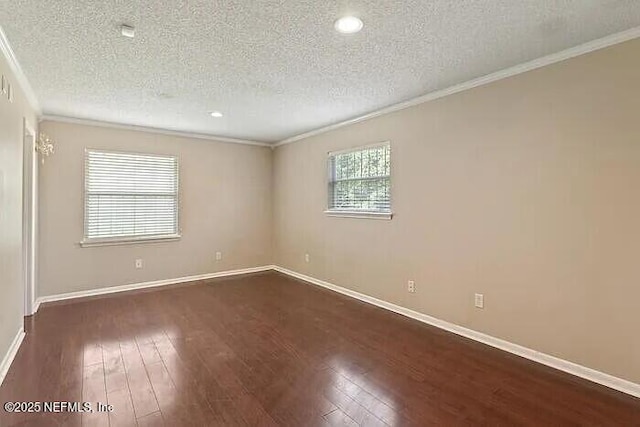 spare room with hardwood / wood-style flooring, crown molding, baseboards, and a textured ceiling