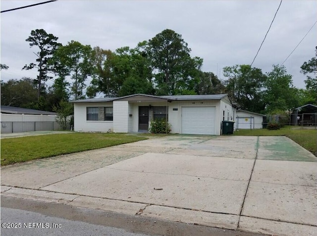 view of front facade with a garage, concrete driveway, a front lawn, and fence