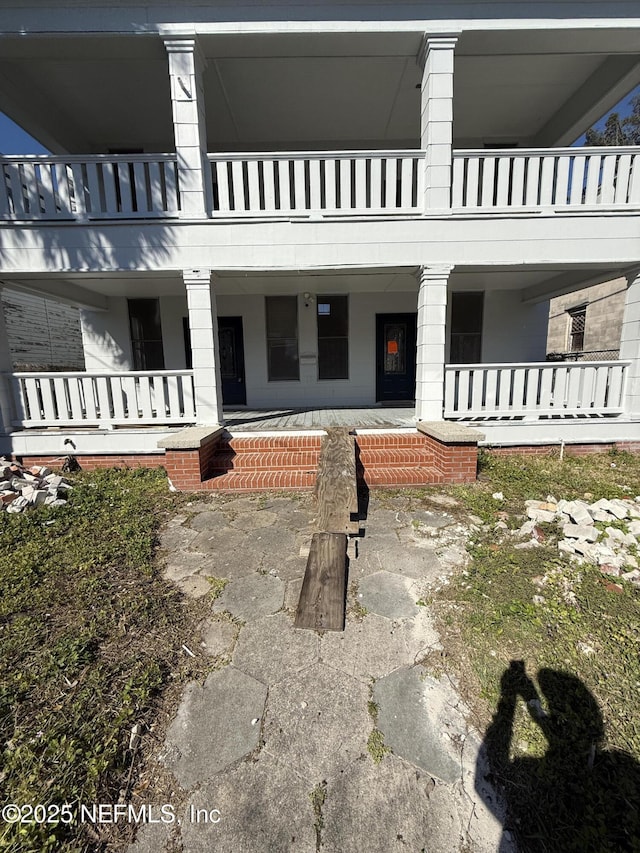 view of patio / terrace with a balcony and covered porch