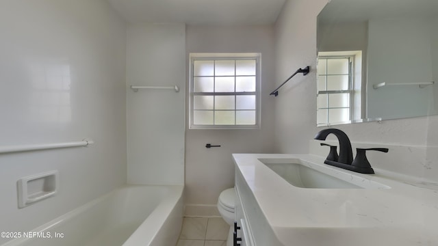 bathroom with vanity, tile patterned floors, toilet, and a bathtub