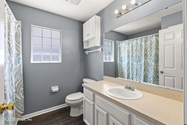 full bath with vanity, toilet, wood finished floors, and baseboards