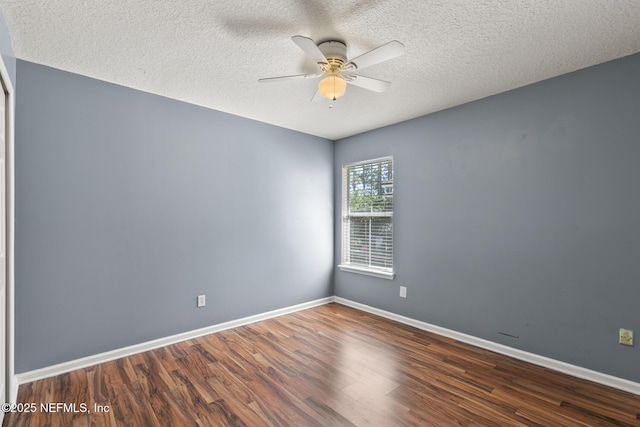 unfurnished room featuring a textured ceiling, baseboards, a ceiling fan, and wood finished floors