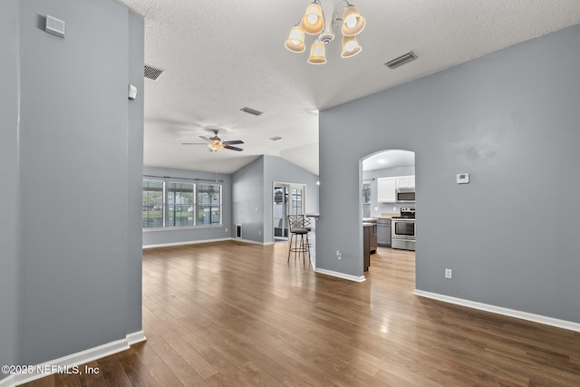 unfurnished living room featuring wood finished floors, visible vents, baseboards, arched walkways, and ceiling fan with notable chandelier