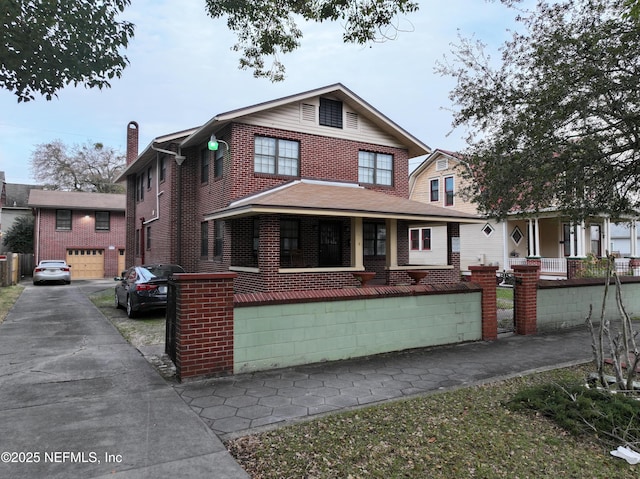 traditional-style house featuring brick siding, a porch, and a chimney