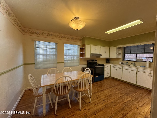 dining room featuring wood finished floors and baseboards