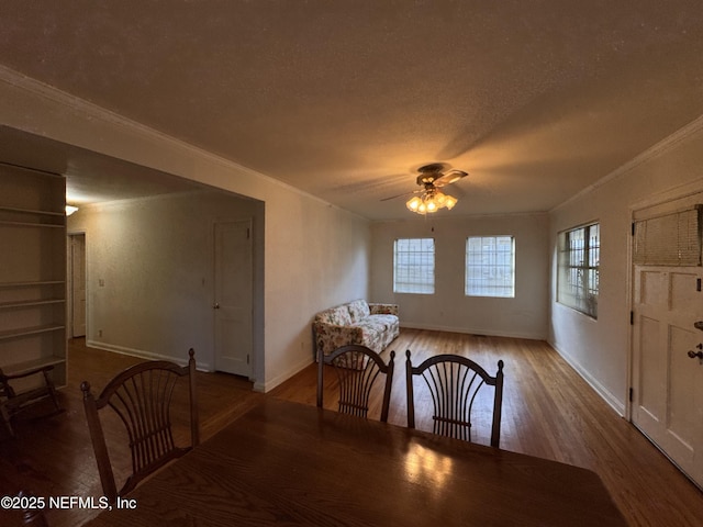 dining area with ornamental molding, a textured ceiling, ceiling fan, and wood finished floors