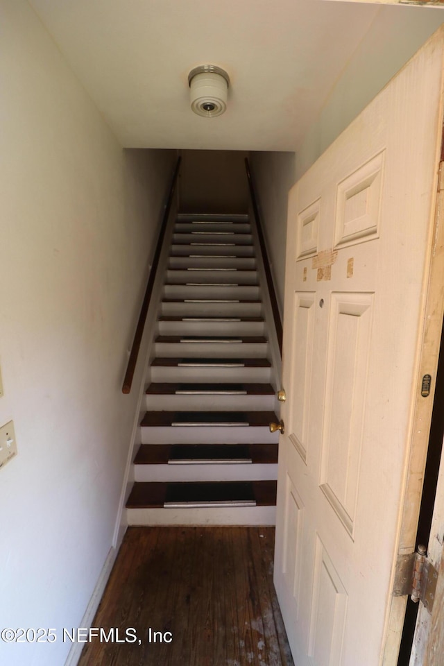 staircase with baseboards and hardwood / wood-style flooring