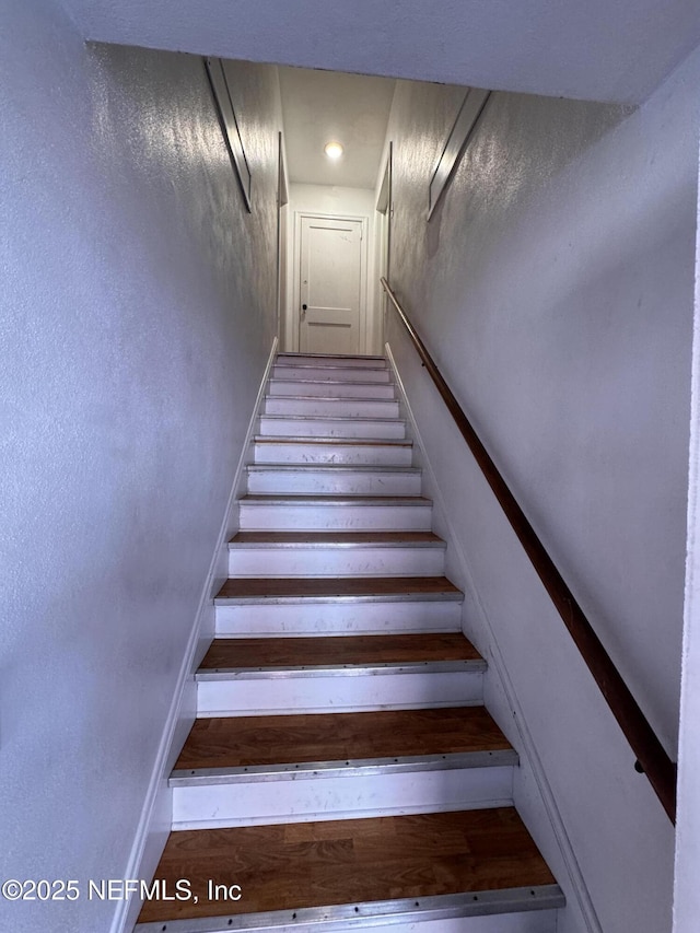 stairway featuring baseboards