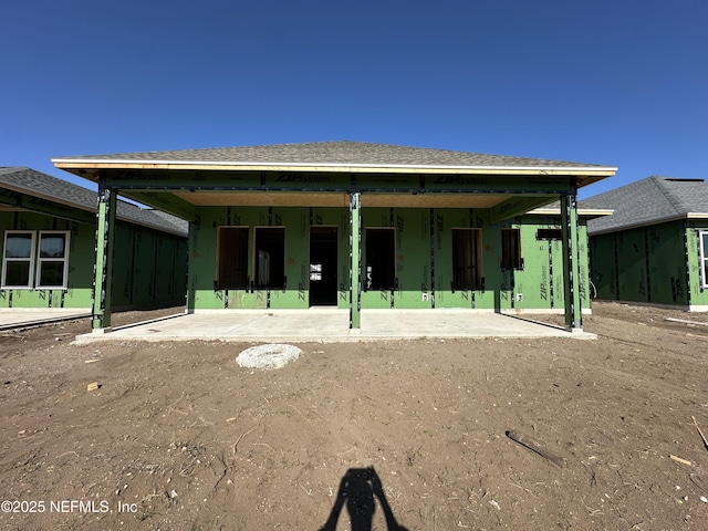 back of property featuring a shingled roof