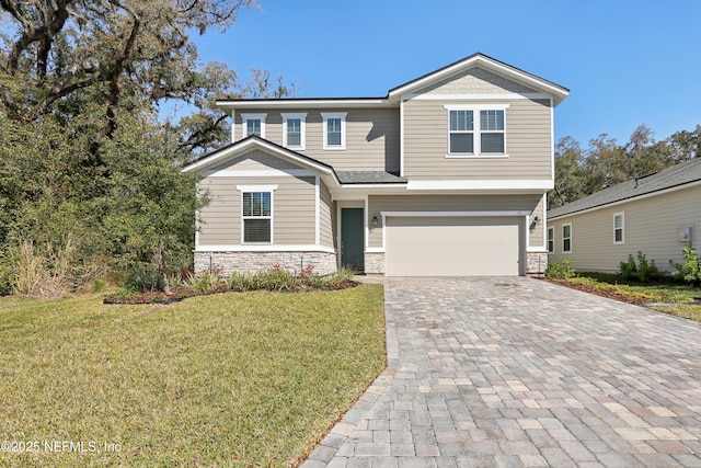 craftsman house featuring a garage, a front yard, decorative driveway, and stone siding