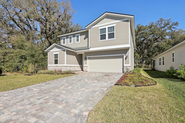 view of front of property with stone siding, a garage, driveway, and a front lawn