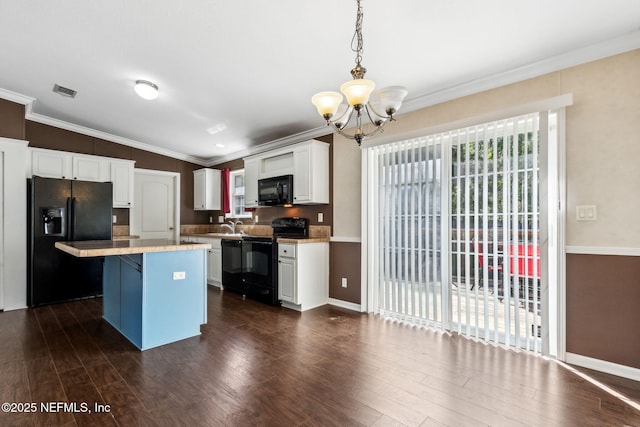 kitchen with black appliances, white cabinets, light countertops, a chandelier, and dark wood-style flooring