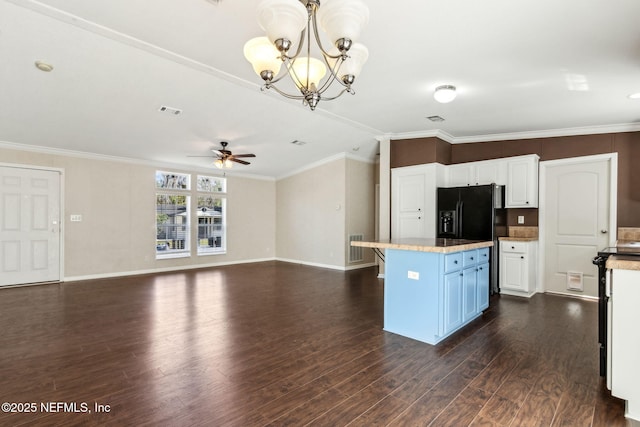 kitchen with a kitchen island, dark wood-style flooring, ornamental molding, white cabinets, and ceiling fan with notable chandelier