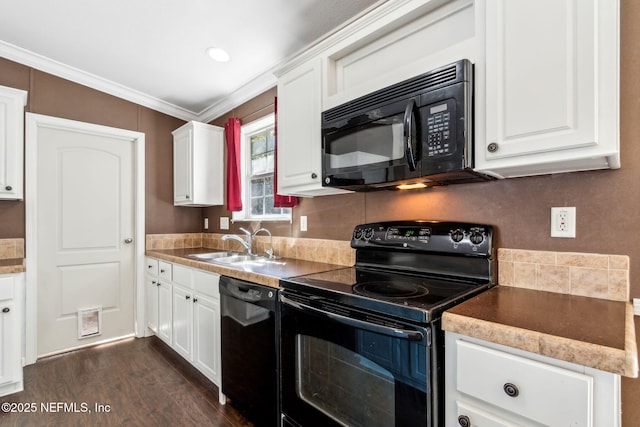 kitchen with dark wood-style flooring, a sink, ornamental molding, black appliances, and white cabinets