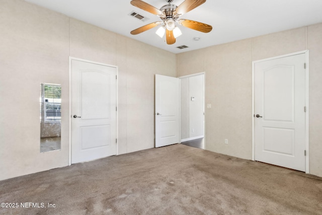 unfurnished bedroom with a ceiling fan, carpet, and visible vents