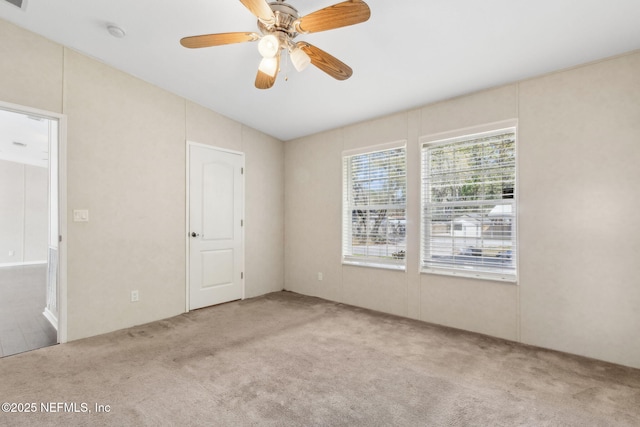 empty room featuring carpet floors and ceiling fan