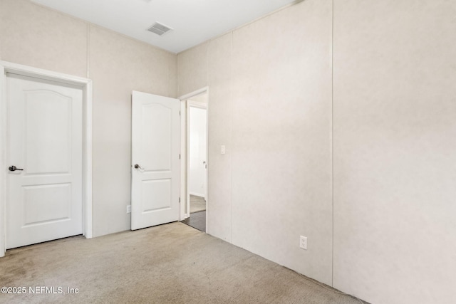 unfurnished bedroom featuring visible vents and carpet