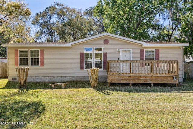 manufactured / mobile home featuring crawl space, a deck, a front yard, and fence