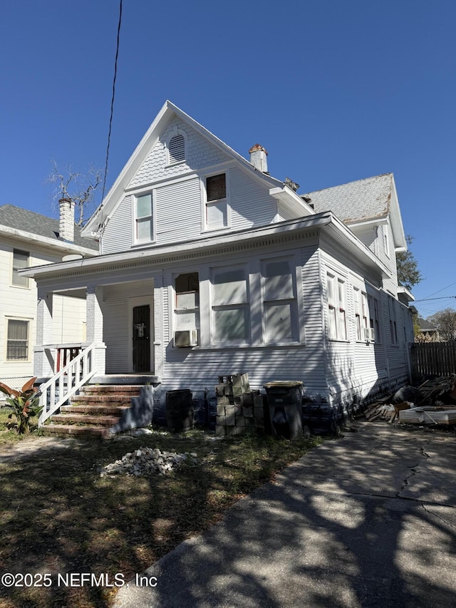 bungalow-style house with covered porch and a chimney