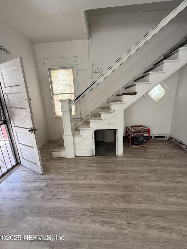 foyer entrance with stairway and wood finished floors