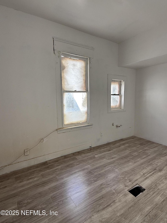 unfurnished room with wood finished floors