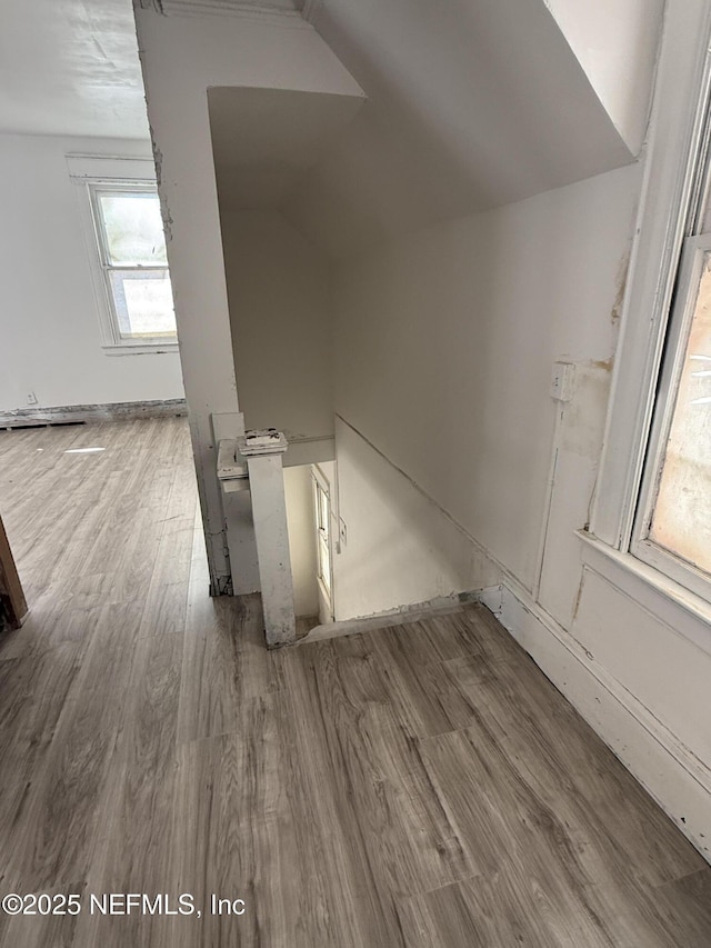 bonus room featuring wood finished floors and vaulted ceiling