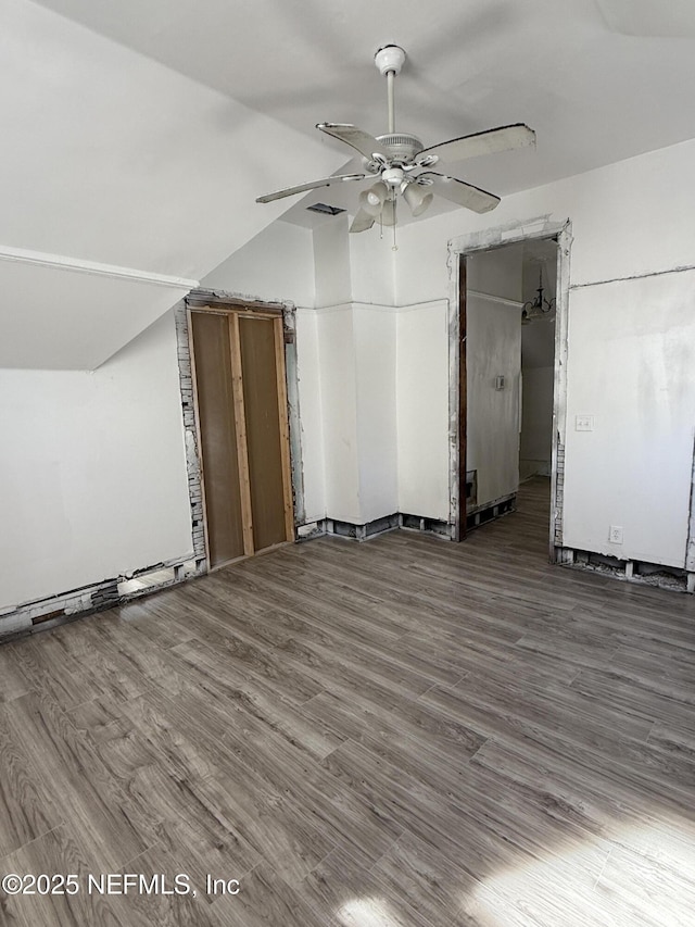 additional living space with a ceiling fan, vaulted ceiling, and wood finished floors