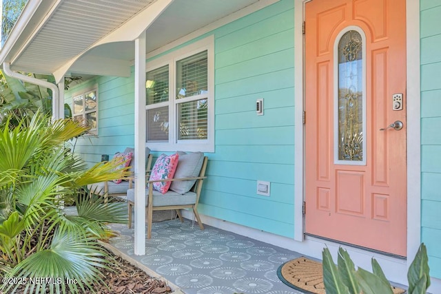 view of exterior entry featuring a porch