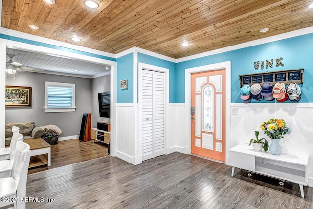 foyer entrance featuring wood finished floors, a wainscoted wall, recessed lighting, wood ceiling, and crown molding